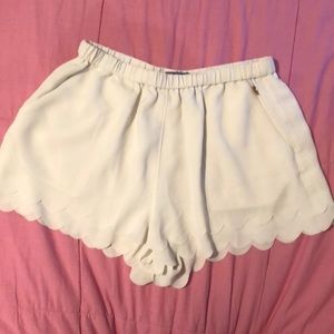 Scalloped white flowy shorts with pockets